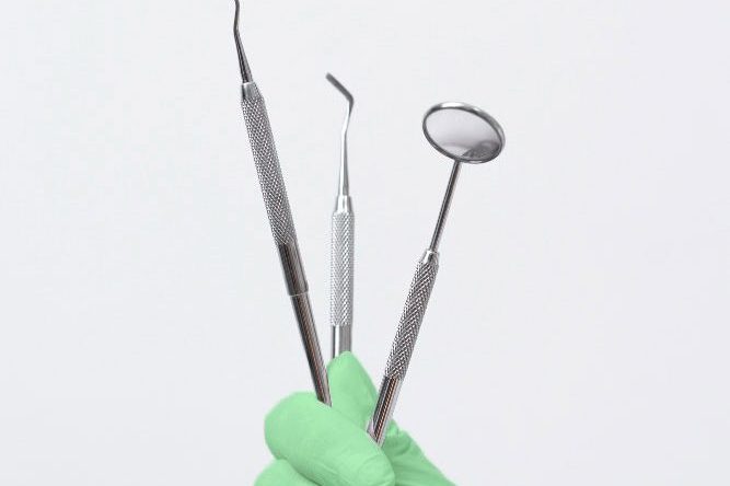 Dentist holding up tools after getting SEO Optimisation