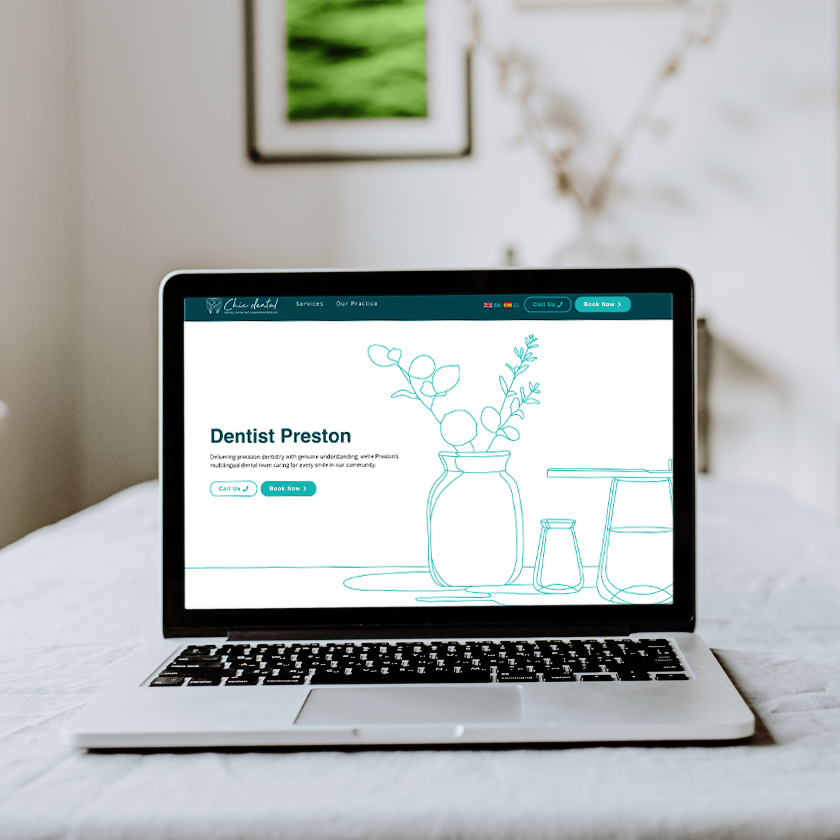 Chic Dental Website design shown off on laptop on a white bedspread